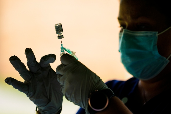 A syringe is prepared with the Pfizer COVID-19 vaccine