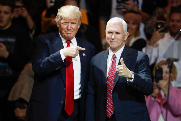 President-elect Donald Trump, left, and Vice President-elect Mike Pence acknowledge the crowd during the first stop of his post-election tour, in Cincinnati on Dec. 1, 2016