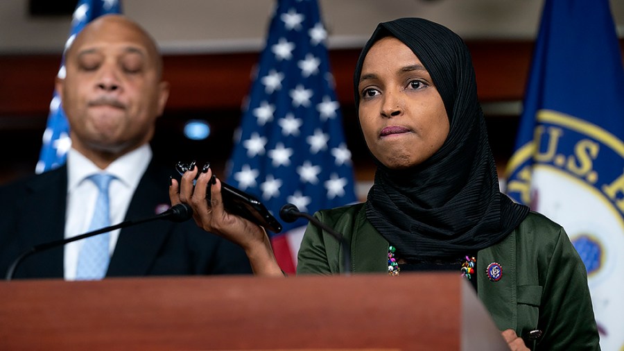 Rep. Ilhan Omar (D-Minn.) holds up her phone to play a hate-filled voice mail during a press conference on Tuesday, November 30, 2021 to call out Rep. Lauren Boebert’s (R-Colo.) anti-Islamic remarks.