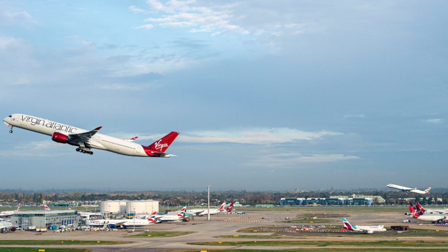 A Virgin Atlantic flight, front, and British Airways flight perform a synchronized departure on parallel runways at London Heathrow Airport