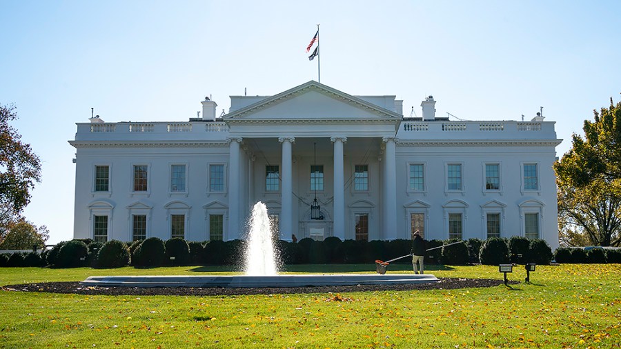 A worker cleans a fountain on the North Lawn of the White House on Friday, November 19, 2021.