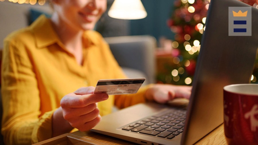 Person using a credit card and laptop to make an online purchase