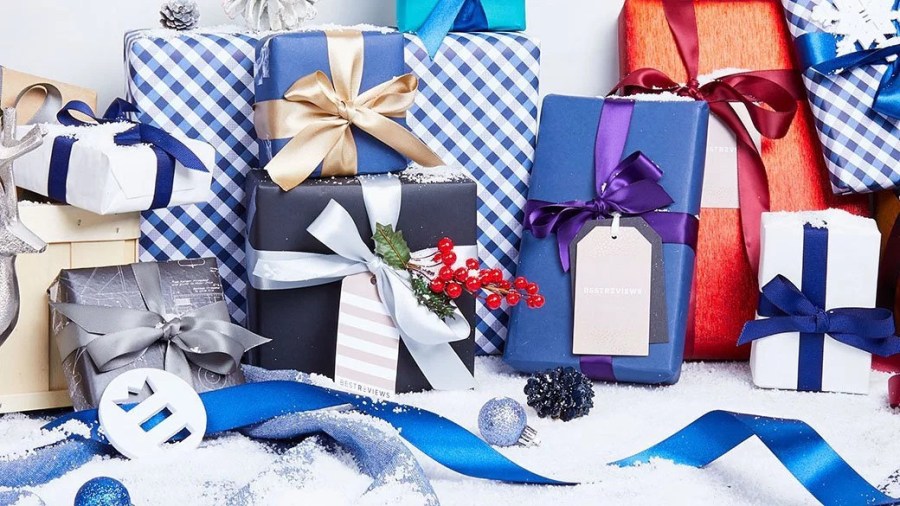 Several gifts sit by ribbon.