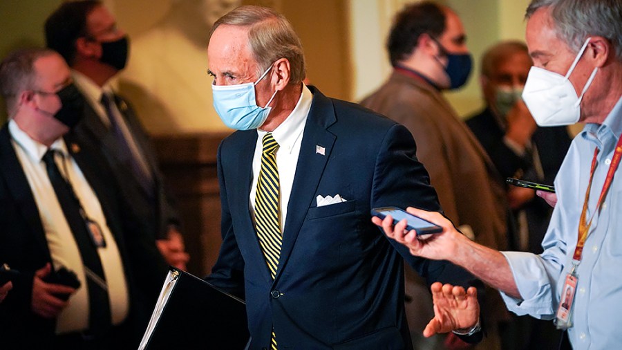 Sen. Tom Carper (D-Del.) speaks to a reporter after the weekly Senate Democratic policy luncheon as heads to a vote in the Senate Chamber on Tuesday, October 19, 2021.