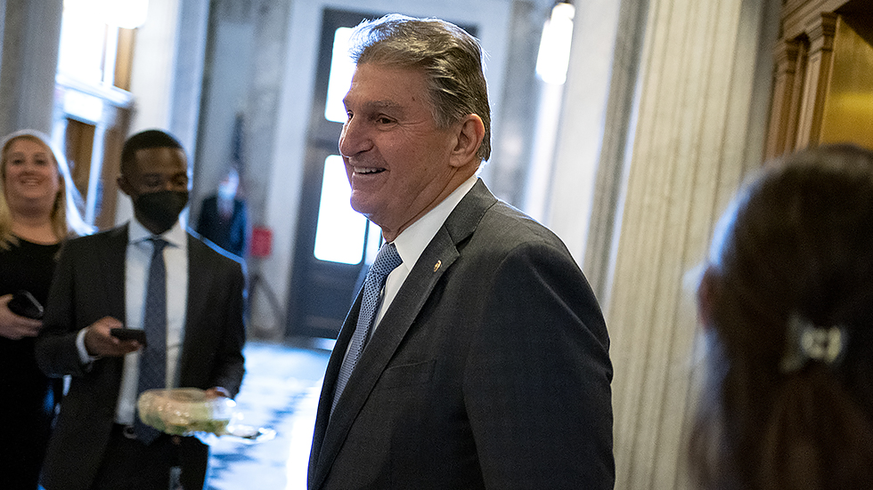 Sen. Joe Manchin (D-W.Va.) arrives to the Senate Chamber for procedural votes regarding nominations on Wednesday, December 8, 2021.