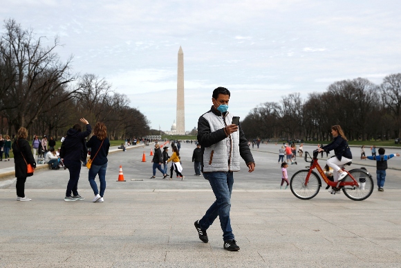 A man wears a face mask as he visits the National Mall in Washington