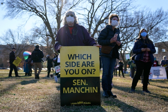 Protesters gather for a rally to press Congress to pass voting rights protections and the "Build Back Better Act"