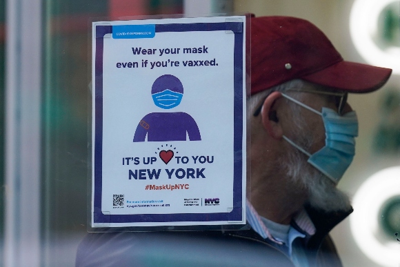 A sign reminds customers that masks are required in their store in New York