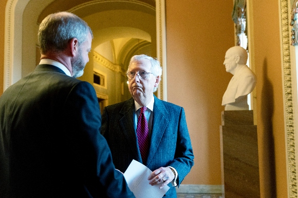 Senate Minority Leader Mitch McConnell, R-Ky., listens to a staffer