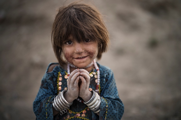 Laila poses for a photo on Sept. 27, 2021, as she plays in a poor neighborhood in Kabul