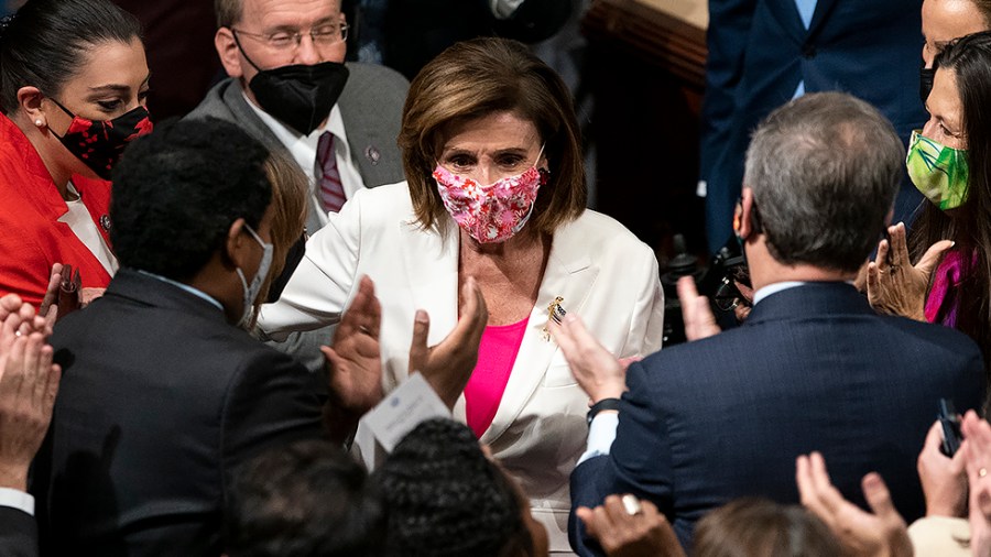 Speaker Nancy Pelosi (D-Calif.) and House Democrats cheer after the passage of the Build Back Better Act in the House Chamber on Friday, November 19, 2021