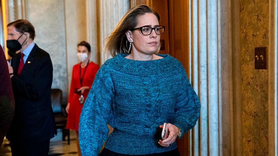 Sen. Kyrsten Sinema (D-Ariz.) leaves the Senate Chamber after a nomination vote on Wednesday, December 15, 2021.