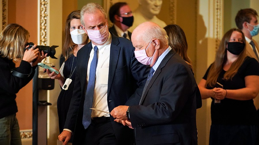 Sens. Chris Van Hollen (D-Md.) and Ben Cardin (D-Md.) leave the weekly Senate Democratic policy luncheon for a vote in the Senate Chamber on Tuesday, October 19, 2021.