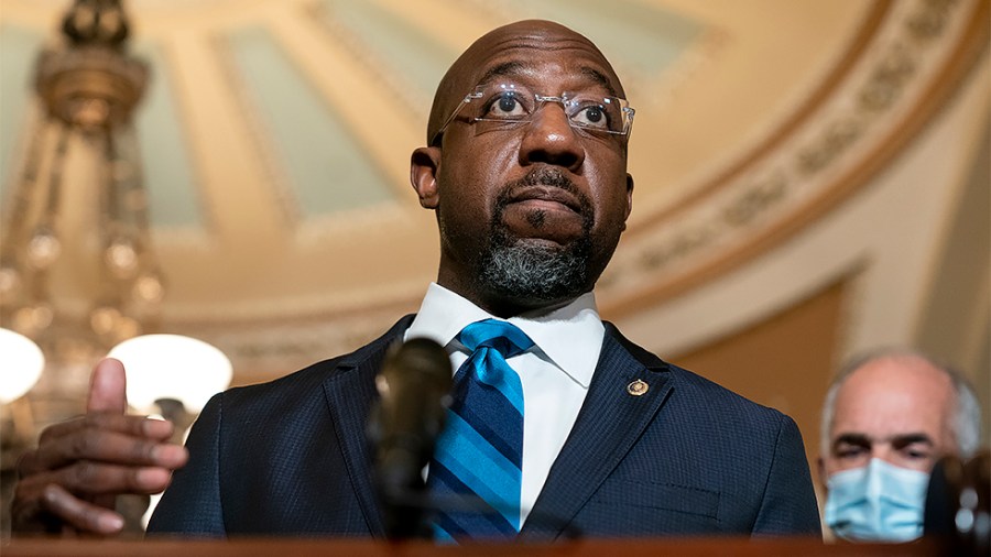 Sen. Raphael Warnock (D-Ga.) addresses reporters after the weekly policy luncheon on Tuesday, December 7, 2021.