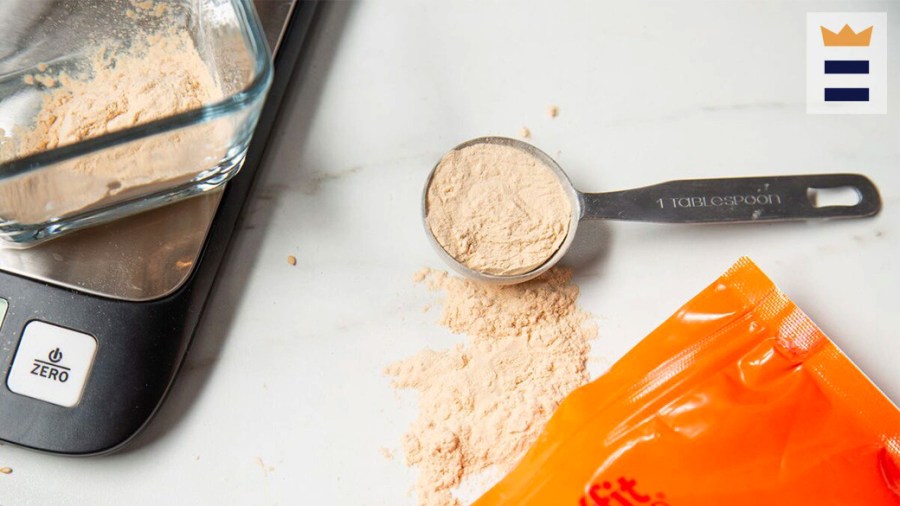 Powder being measured by the tablespoon and on a scale