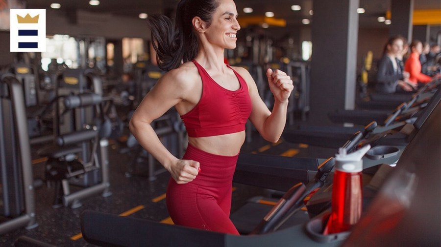 Woman running on a treadmill in a gym