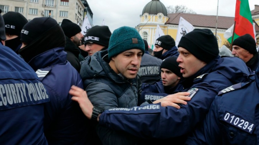 Policemen push protesters away from the Bulgarian Parliament building in Sofia