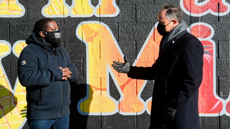 Second gentleman Doug Emhoff, the spouse of Vice President Kamala Harris, right, speaks with Christopher Bradshaw, executive director of Dreaming out Loud