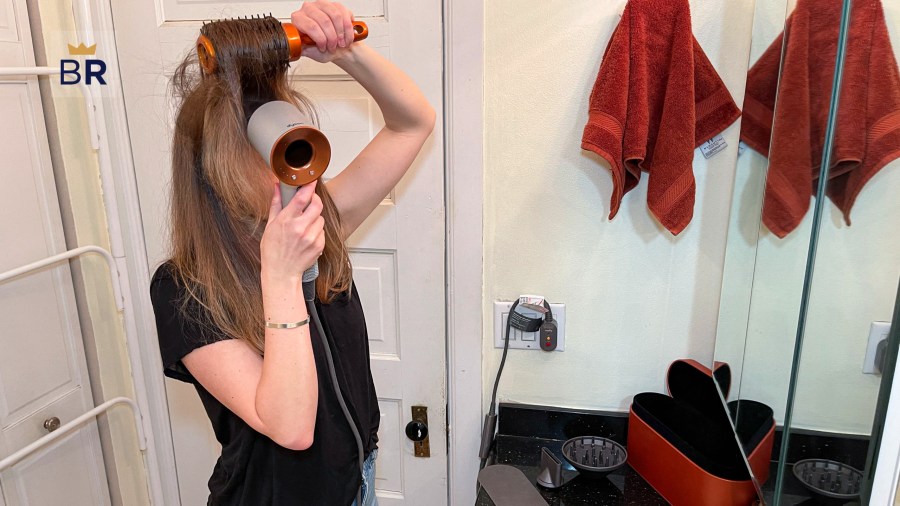 Woman drying her hair using the Dyson Supersonic