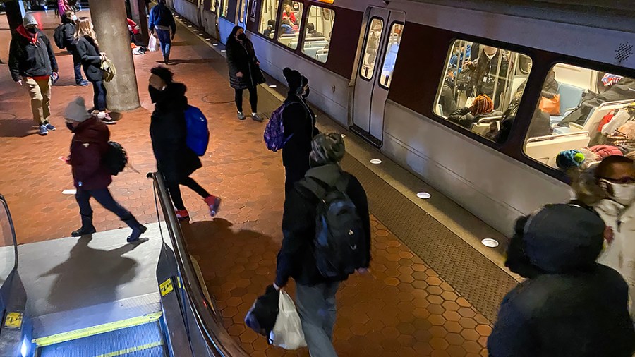 Riders are seen at Metro Center in Washington, D.C., on Monday, January 24, 2022.