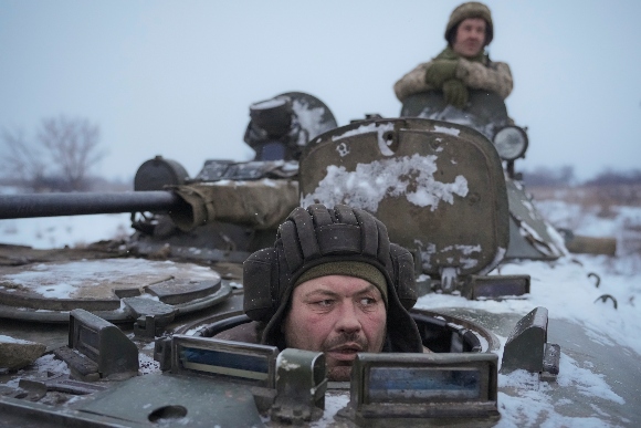 Ukrainians drive in an armored personnel carrier near front line position in the Luhansk area, in eastern Ukraine