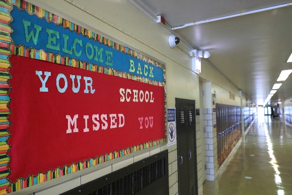 A Welcome Back sign on a bulletin board Thursday, Feb. 11, 2021, greets returning students at Chicago's William H. Brown Elementary School