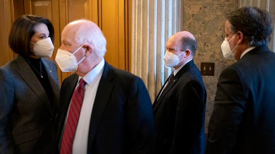 Sens. Catherine Cortez Masto (D-Nev.), Ben Cardin (D-Md.), Chris Coons (D-Del.) and Gary Peters (D-Mich.) are seen near the Senate Chamber during a notation vote on Wednesday, January 5, 2022.