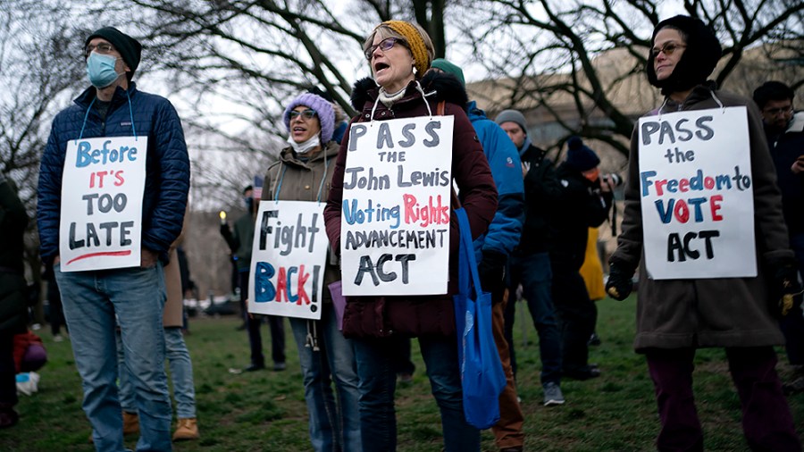 Pro-Democratic supporters are seen during a vigil to mark the first anniversary of the attack on the Capitol and to support voting rights on Thursday, January 6, 2022.