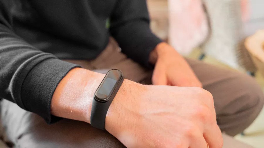 Person wearing a Fitbit on their wrist