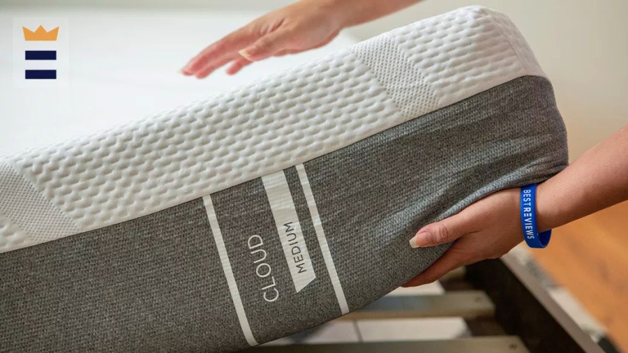 Person centering a mattress on a bed frame