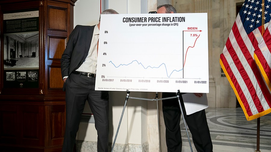 Sen. Rob Portman (R-Ohio) speaks to Sen. Mike Crapo (R-Idaho) behind an inflation sign during a press conference on Wednesday, February 16, 2022 to discuss inflation during President Biden’s administration.