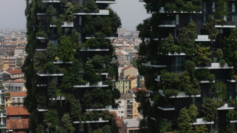 The twin towers of the "Bosco Verticale," or Vertical Forest, residential buildings at the Porta Nuova district, frame a view of Milan