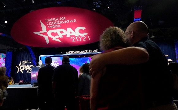 Conservative supporters look on as Rabbi Yitz Tender leads a prayer during the opening general session of the Conservative Political Action Conference