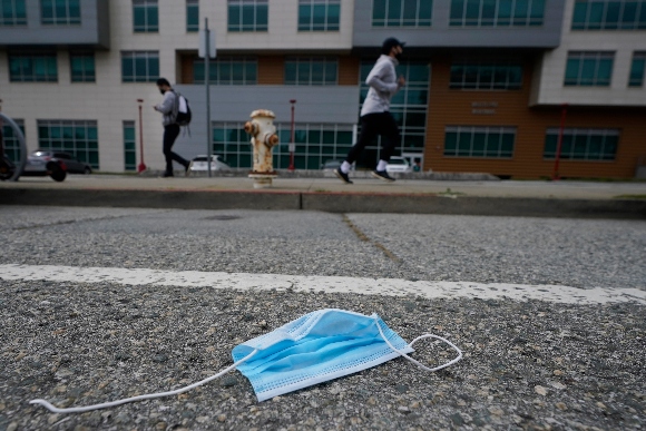 A discarded face mask lies in the street in San Francisco