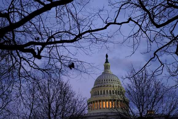 Light shines from the U.S. Capitol dome after sunset