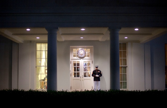 A Marine Honor Guard stands watch at the entrance to the West Wing of the White House