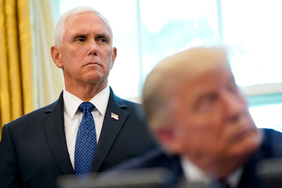 President Donald Trump and Vice President Mike Pence listen during an announcement in the Oval Office