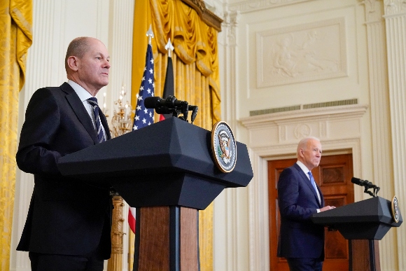 President Joe Biden and German Chancellor Olaf Scholz listen to a question from a reporter