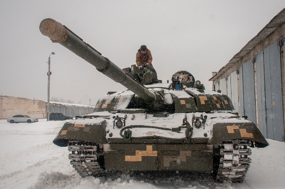 Ukrainian soldiers examine their tank at a military unit close to Kharkiv