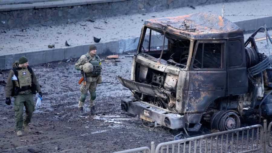 Ukrainian troops inspect the site following a Russian airstrike in Kyiv