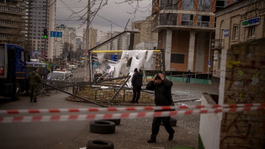 Police officers inspect area after an apparent Russian strike in Kyiv