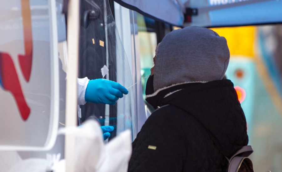 person getting a nasal swab at a testing station