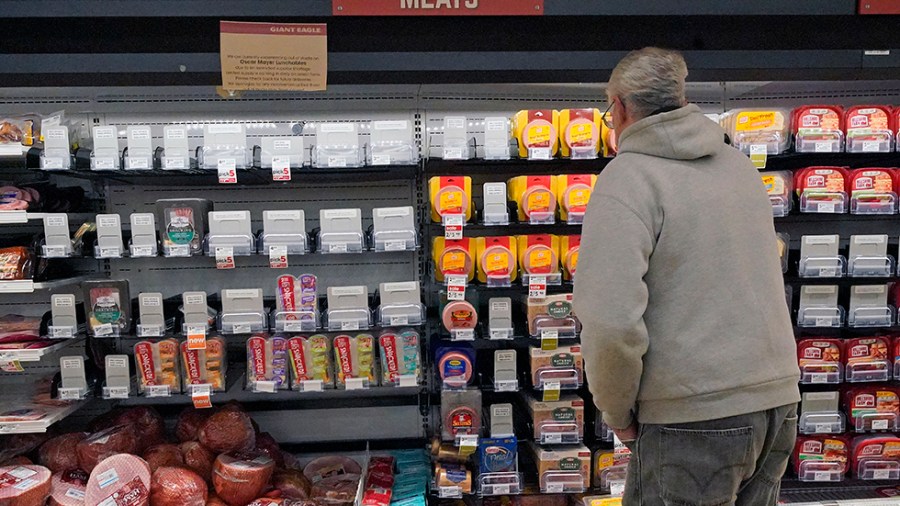 A shopper looks at grocery items