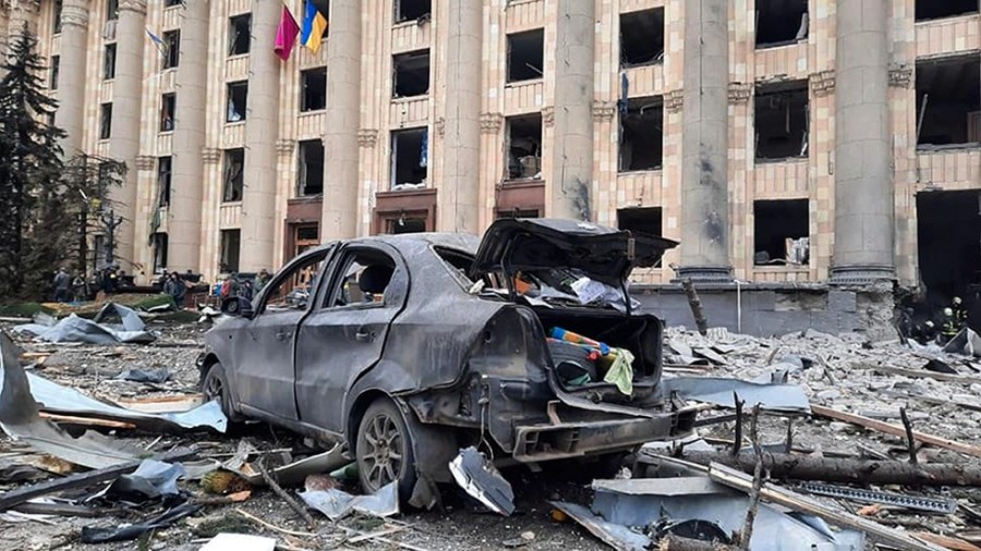 In this handout photo released by Ukrainian Emergency Service, a burnt car is seen in front of a damaged City Hall building, in Kharkiv