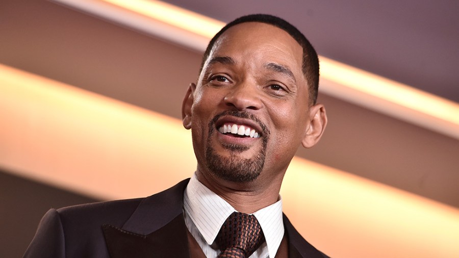 Will Smith poses in the press room with the award for best actor for "King Richard"