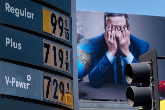 Gas prices are seen in front of a billboard advertising HBO's Last Week Tonight in Los Angeles