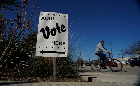 Voters leave an early voting poll site, Monday, Feb. 14, 2022, in San Antonio