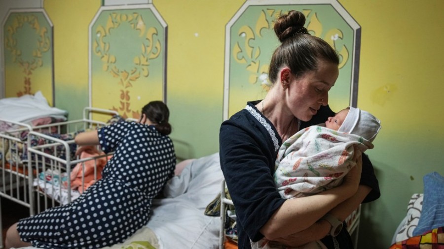 Kateryna Suharokova holds her newborn son Makar in the basement of a maternity hospital converted into a medical ward and used as a bomb shelter in Mariupol