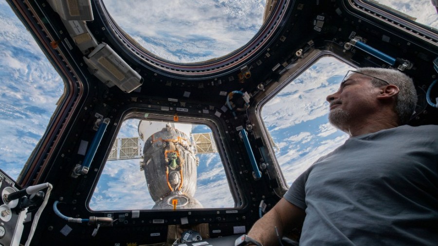 In this photo provided by NASA, U.S. astronaut and Expedition 66 Flight Engineer Mark Vande Hei peers at the Earth