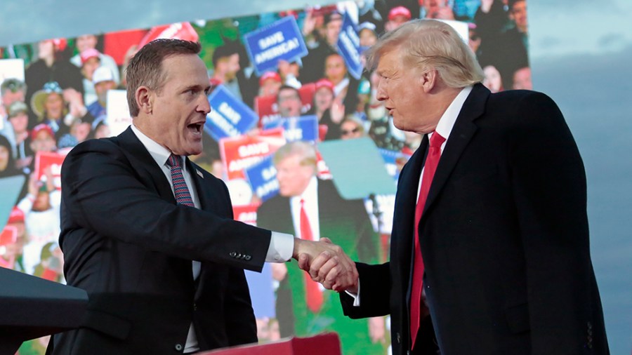 Republican candidate for U.S. Senate Ted Budd, left, shakes hands with former President Trump